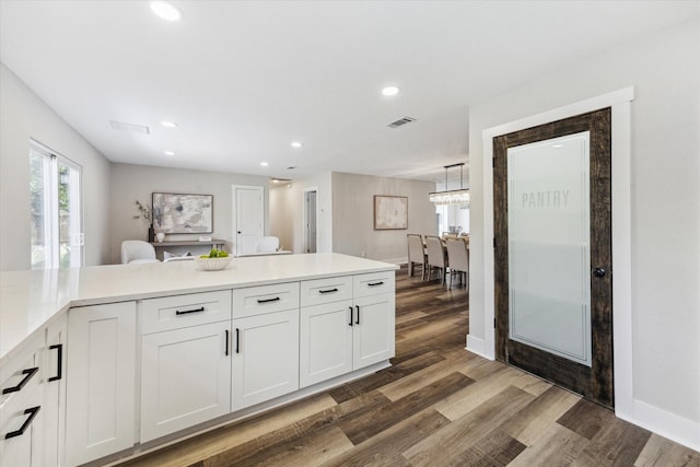 kitchen featuring recessed lighting, light countertops, visible vents, white cabinets, and wood finished floors