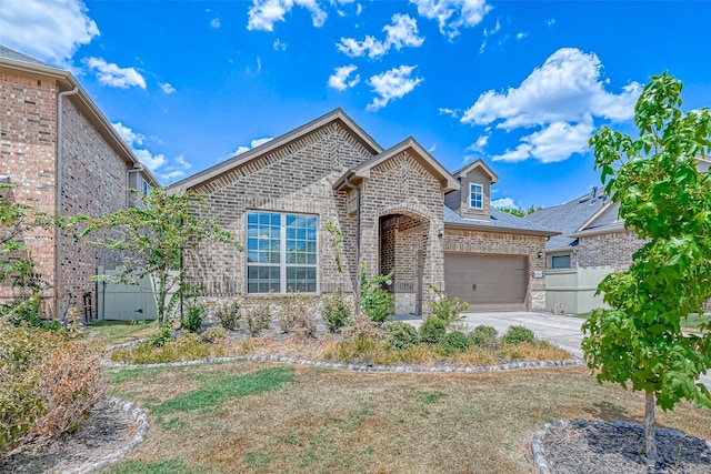 view of front of home featuring an attached garage, concrete driveway, and brick siding