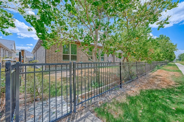 exterior space with brick siding and fence private yard