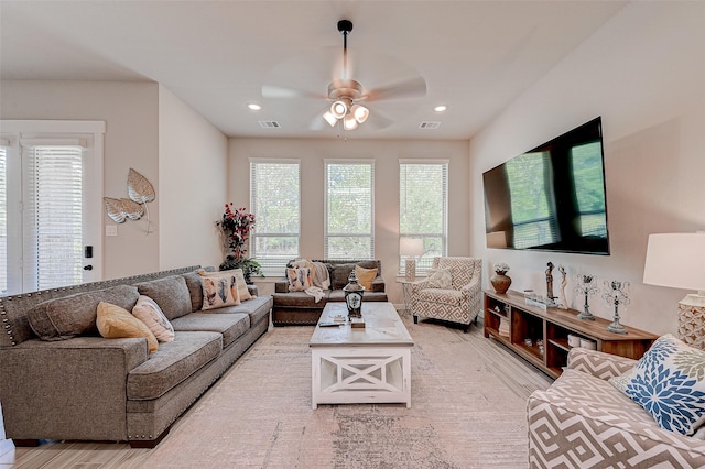 living area featuring ceiling fan, light wood-style floors, visible vents, and recessed lighting