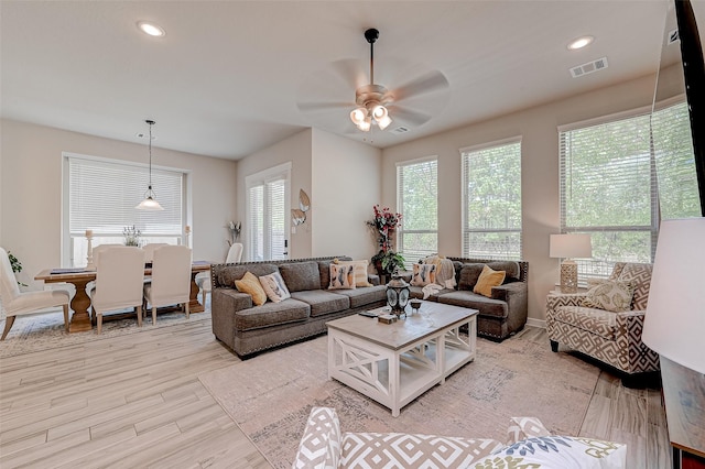 living area featuring light wood-type flooring, visible vents, ceiling fan, and recessed lighting