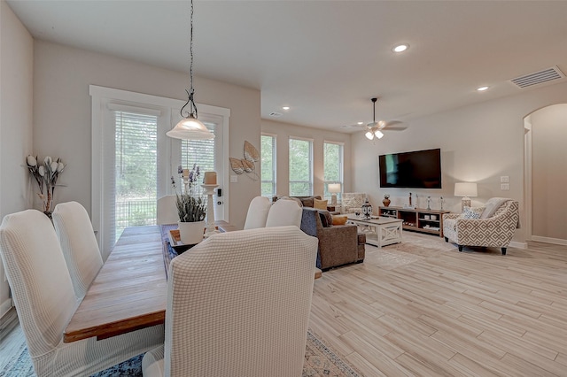 dining room with arched walkways, recessed lighting, a ceiling fan, visible vents, and light wood-type flooring