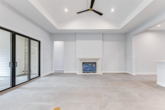 unfurnished living room featuring ceiling fan, recessed lighting, baseboards, vaulted ceiling, and a glass covered fireplace