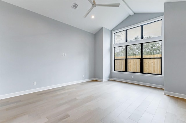 unfurnished room with light wood finished floors, beamed ceiling, visible vents, and baseboards