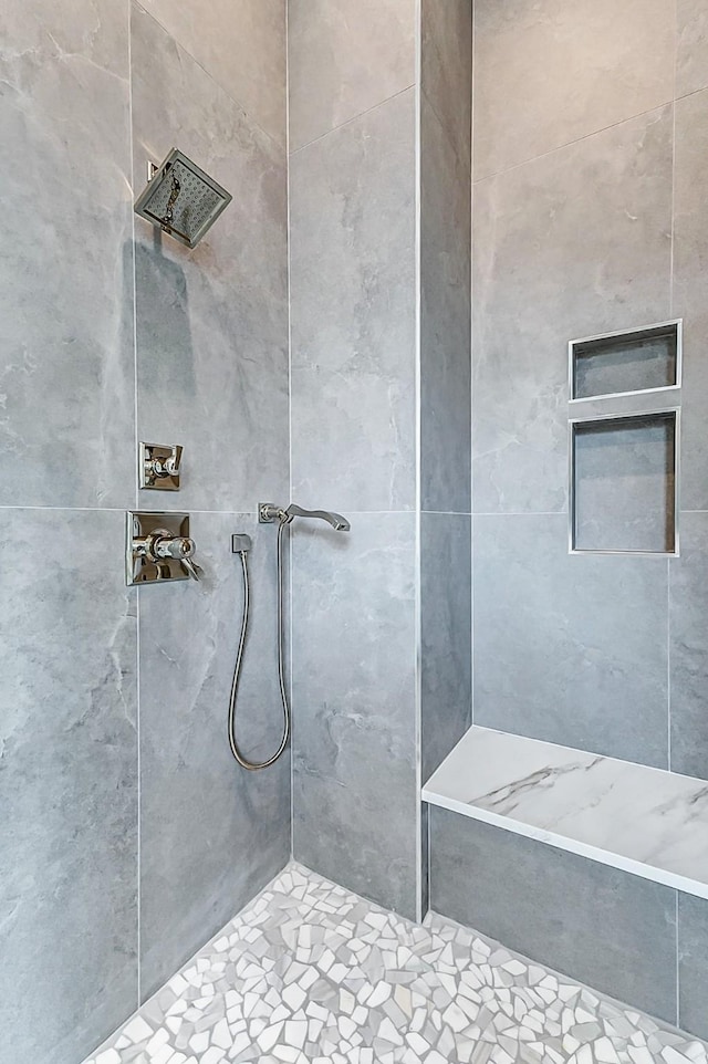 full bathroom with tiled shower