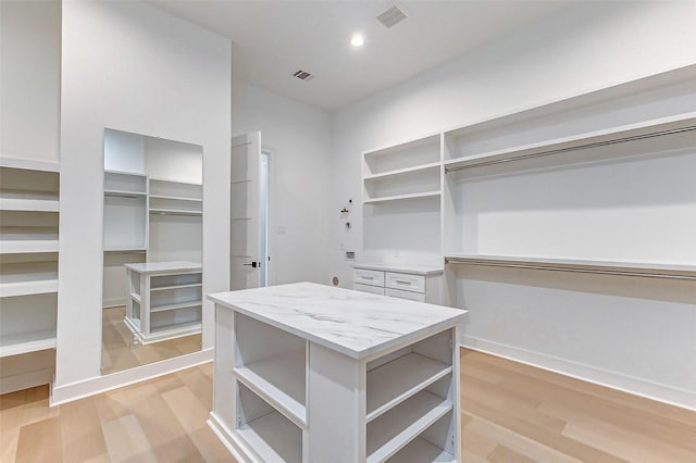 spacious closet featuring light wood-style floors and visible vents