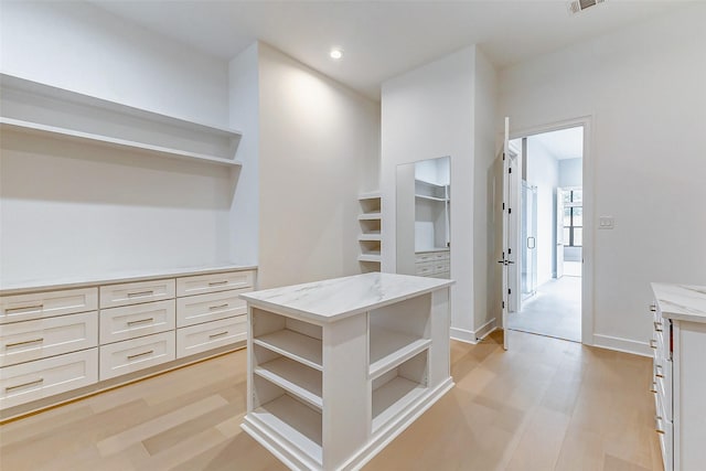 spacious closet featuring light wood-type flooring and visible vents