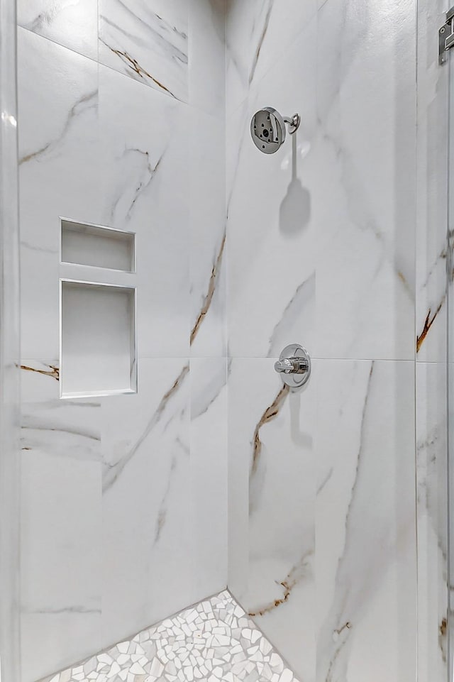 details featuring a marble finish shower