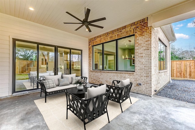 view of patio featuring fence, an outdoor living space, and ceiling fan