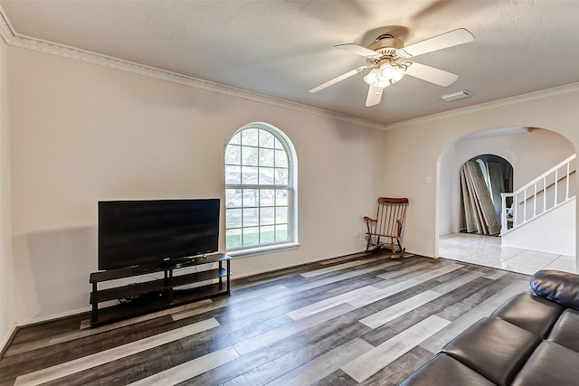 sitting room featuring crown molding, wood finished floors, arched walkways, and ceiling fan