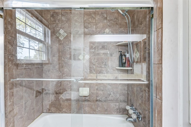 bathroom featuring shower / bath combination with glass door