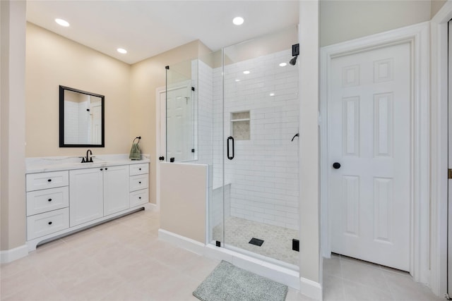 full bath featuring baseboards, recessed lighting, a stall shower, tile patterned floors, and vanity