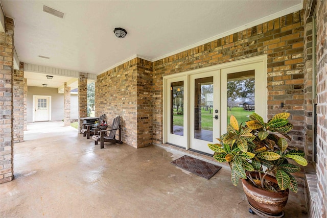 view of patio featuring french doors and visible vents