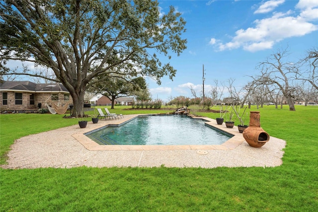 outdoor pool with a patio and a lawn