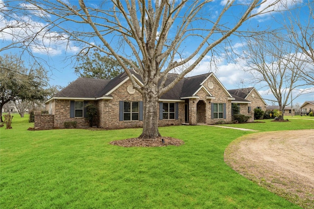 single story home featuring a front lawn and brick siding