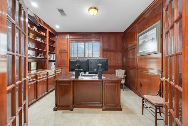 office featuring a decorative wall, french doors, and visible vents