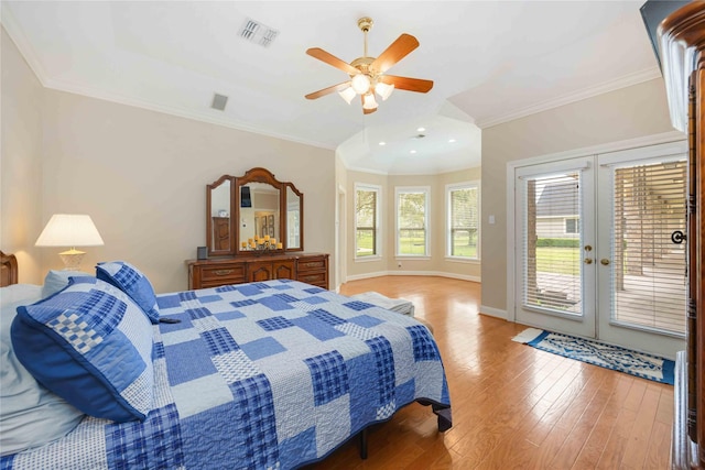 bedroom with visible vents, ornamental molding, a ceiling fan, hardwood / wood-style flooring, and access to outside