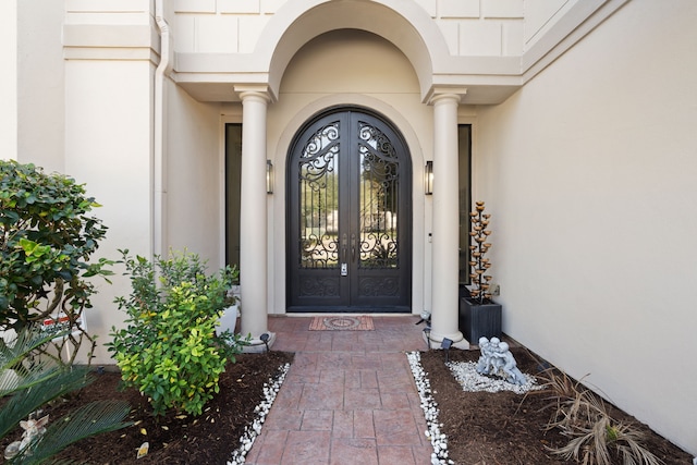 property entrance with french doors and stucco siding