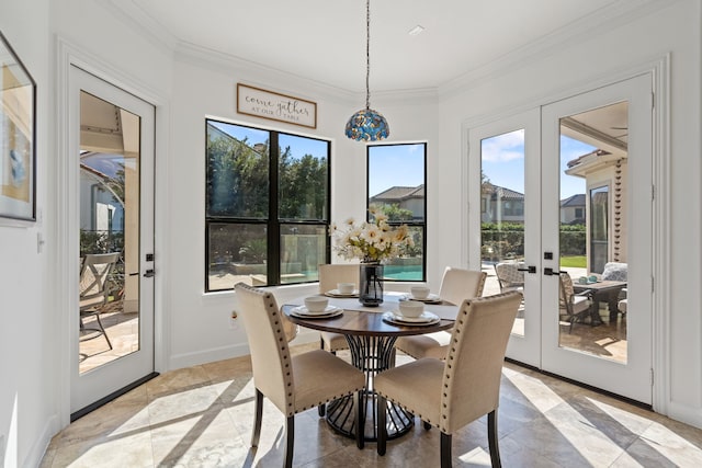 dining area with french doors, crown molding, and baseboards