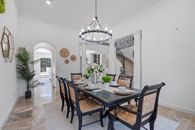 dining room featuring baseboards, arched walkways, crown molding, and ornate columns