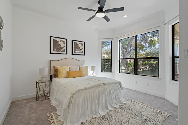 carpeted bedroom with recessed lighting, a ceiling fan, baseboards, and ornamental molding