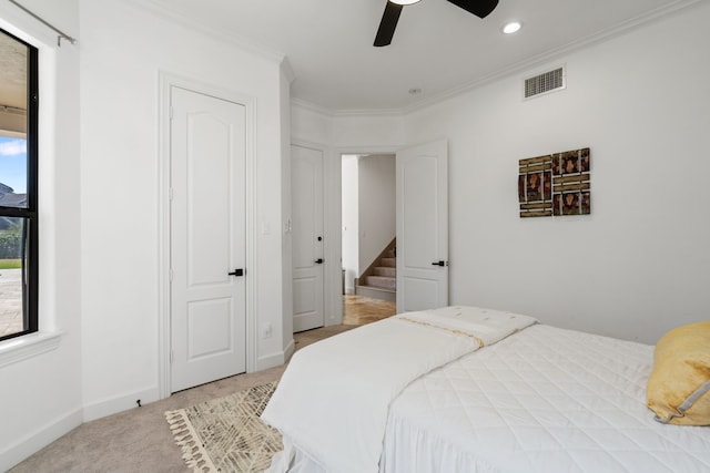 bedroom with visible vents, crown molding, baseboards, light colored carpet, and recessed lighting