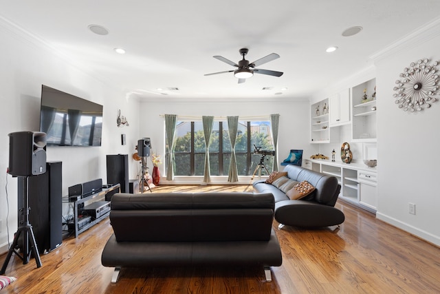 living area featuring a ceiling fan, baseboards, light wood-style flooring, recessed lighting, and crown molding