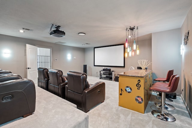 cinema room featuring visible vents and carpet flooring