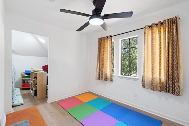 workout area with baseboards and wood finished floors