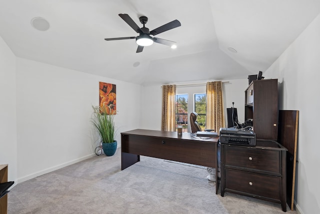 office area featuring light carpet, baseboards, ceiling fan, and vaulted ceiling