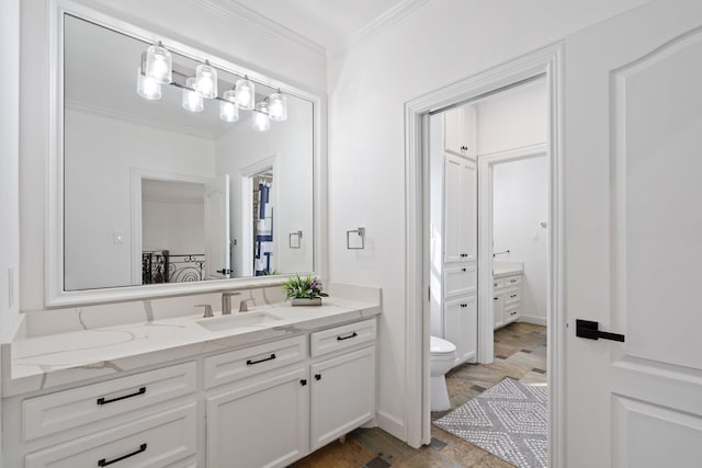 bathroom with toilet, vanity, and ornamental molding