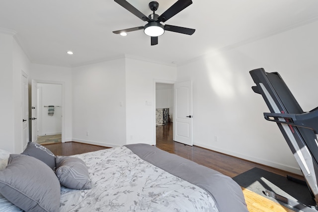 bedroom with recessed lighting, crown molding, baseboards, and wood finished floors