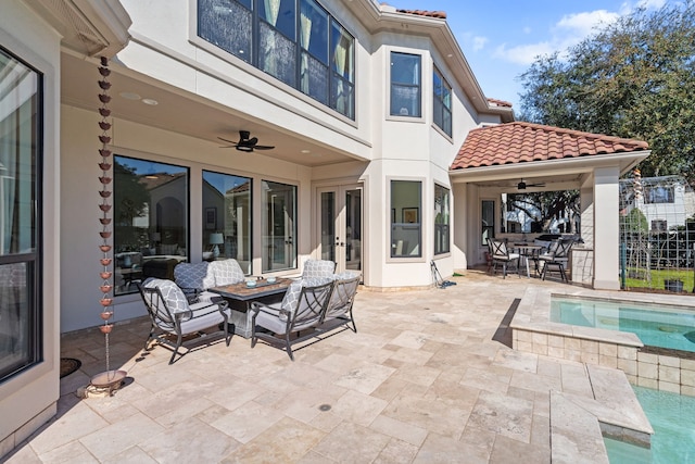 view of patio featuring outdoor dining area, an outdoor pool, french doors, and a ceiling fan