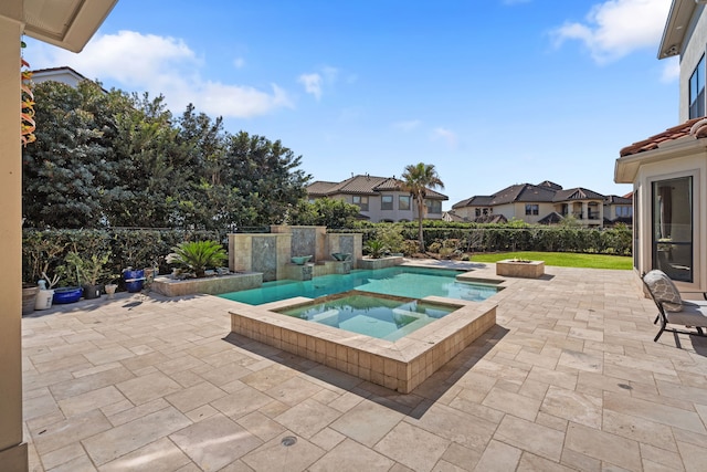 view of swimming pool with an in ground hot tub, fence, a residential view, and a patio