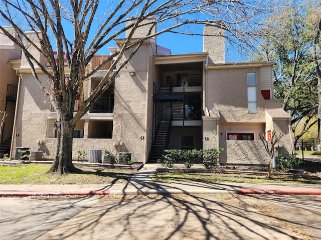 view of property with central AC and stairway