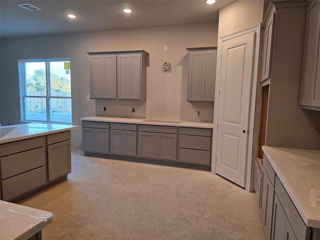 kitchen with recessed lighting, visible vents, concrete flooring, and gray cabinetry