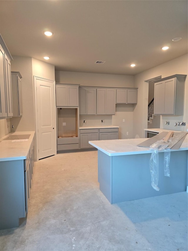 kitchen with visible vents, concrete floors, and gray cabinetry