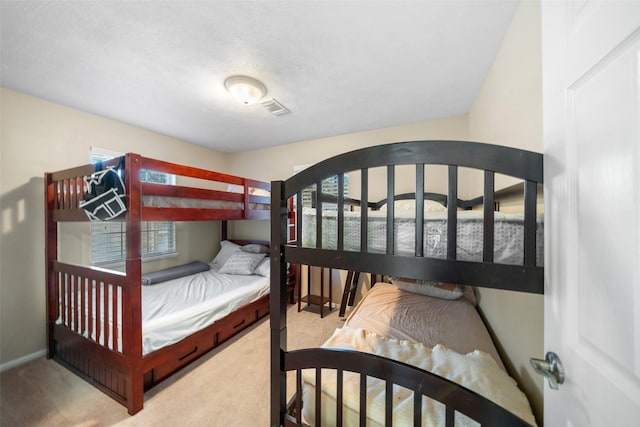 bedroom featuring carpet floors, visible vents, and baseboards