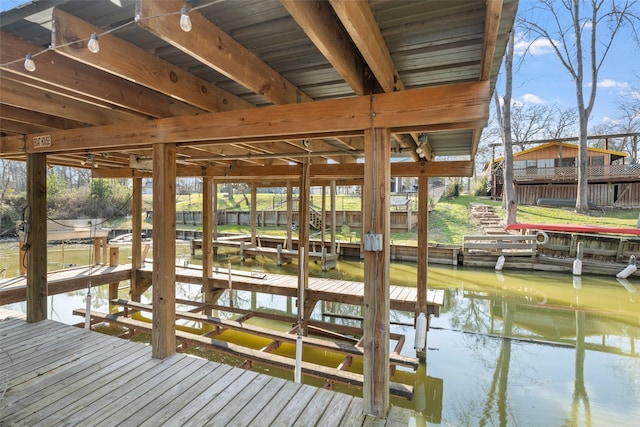 dock area with a water view and boat lift