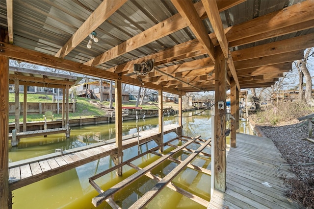 dock area with a water view and boat lift