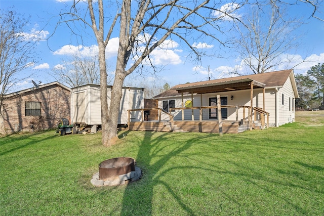 view of yard with a fire pit and a wooden deck