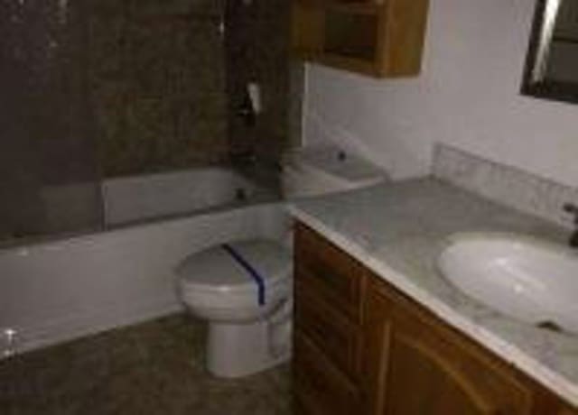 bathroom with shower / washtub combination, vanity, and toilet