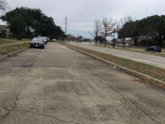 view of street with sidewalks and curbs