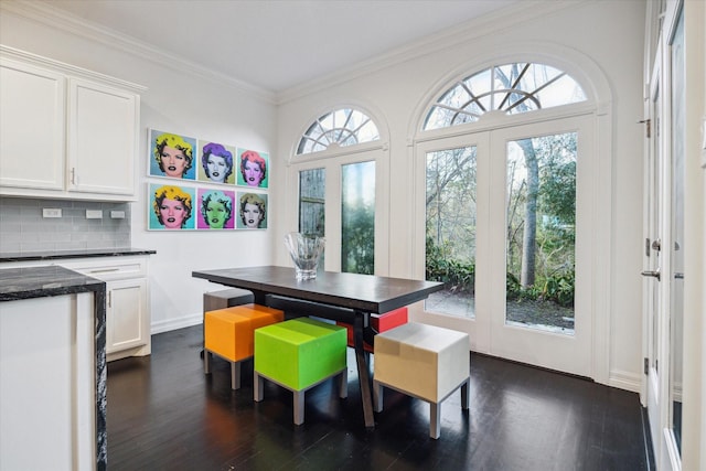 dining area featuring ornamental molding, french doors, baseboards, and dark wood-style floors