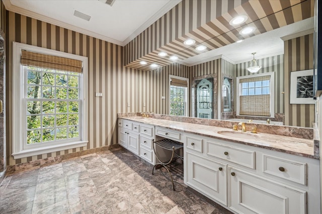 full bathroom with wallpapered walls, crown molding, and a sink