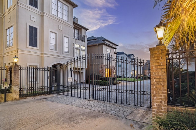 gate at dusk featuring fence