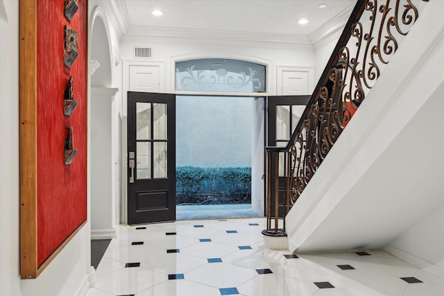 foyer entrance with recessed lighting, visible vents, ornamental molding, baseboards, and stairs