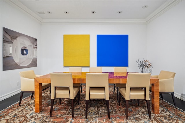 dining room featuring ornamental molding, baseboards, and wood finished floors