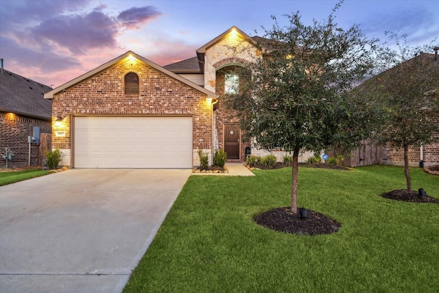 view of front of property featuring driveway, brick siding, an attached garage, fence, and a front yard