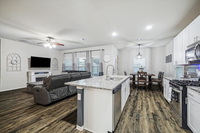 kitchen featuring appliances with stainless steel finishes, dark wood finished floors, visible vents, and a sink